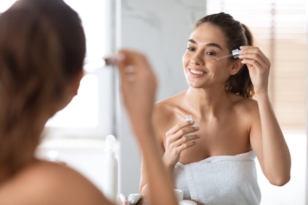 Woman Applying Medical Grade Skincare Recommended by Houston aesthetician at Basu Aesthetics + Plastic Surgery