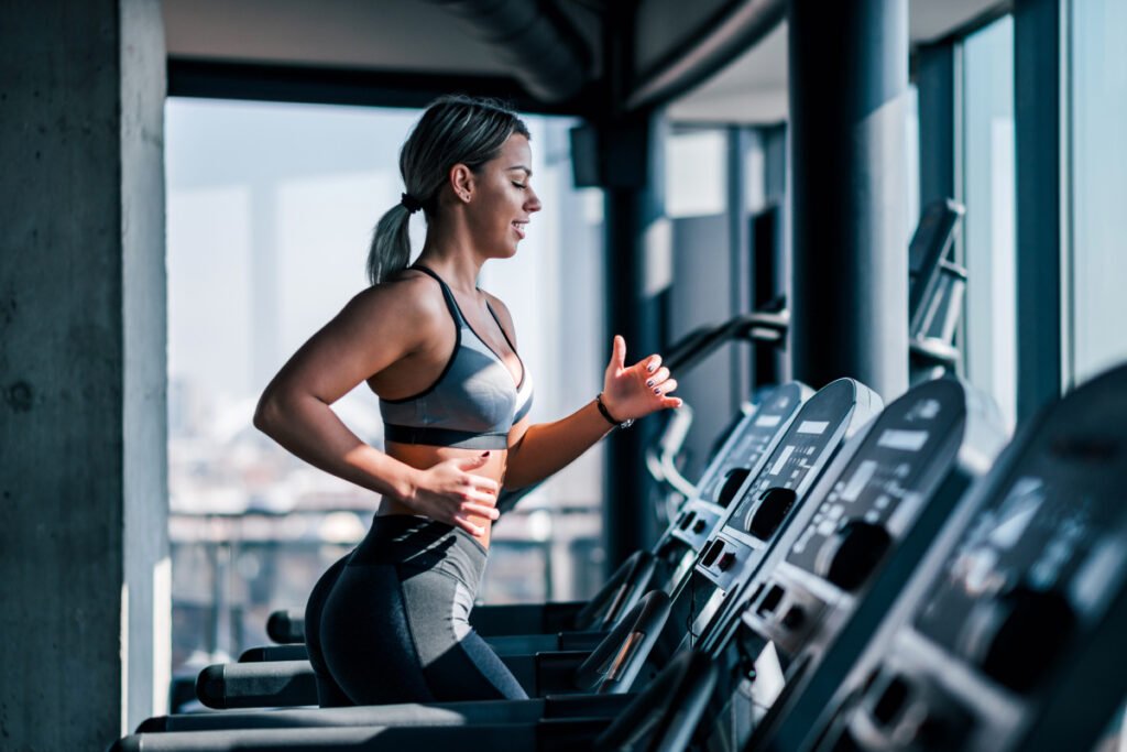 Woman running on treadmill during weight loss program