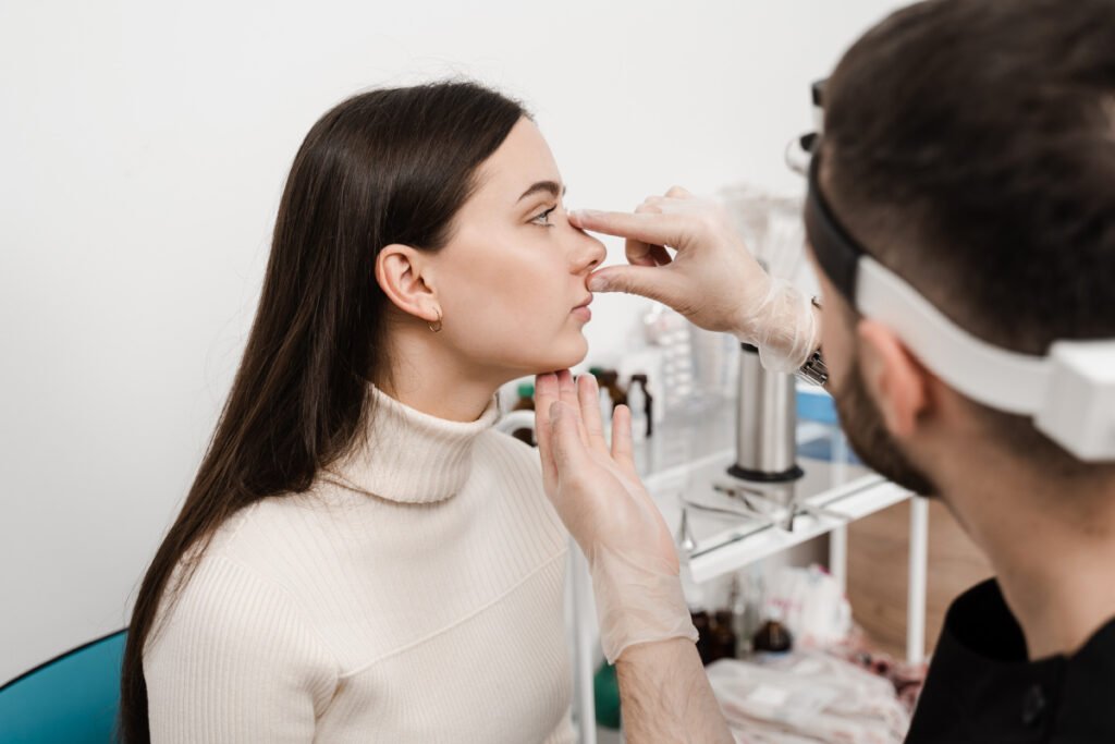 Woman with a facial plastic surgeon at a Houston rhinoplasty consultation